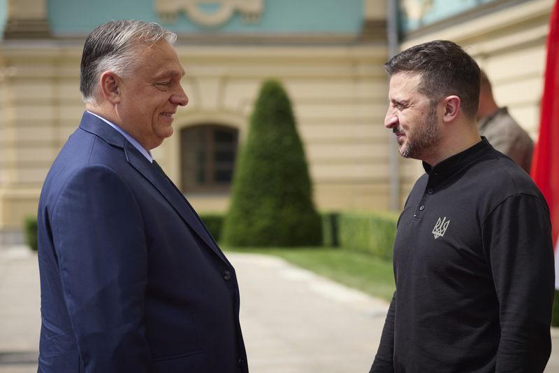 In this photo provided by the Ukrainian Presidential Press Office, Ukrainian President Volodymyr Zelenskyy, right, welcomes Hungarian Prime Minister Viktor Orban in Kyiv, Ukraine, Tuesday, July 2, 2024. (Ukrainian Presidential Press Office via AP)