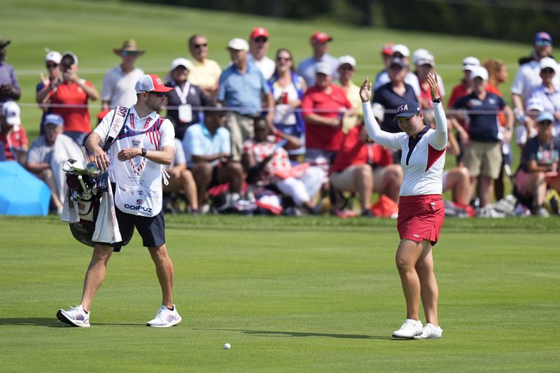 United States' Allisen Corpuz rallies the crowd on the 14th fairway during a Solheim Cup golf tournament singles match at the Robert Trent Jones Golf Club, Sunday, Sept. 15, 2024, in Gainesville, Va. (AP Photo/Chris Szagola)