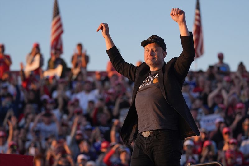 Elon Musk arrives on the stage as Republican presidential nominee former President Donald Trump speaks at a campaign rally at the Butler Farm Show, Saturday, Oct. 5, 2024, in Butler, Pa. (AP Photo/Evan Vucci)