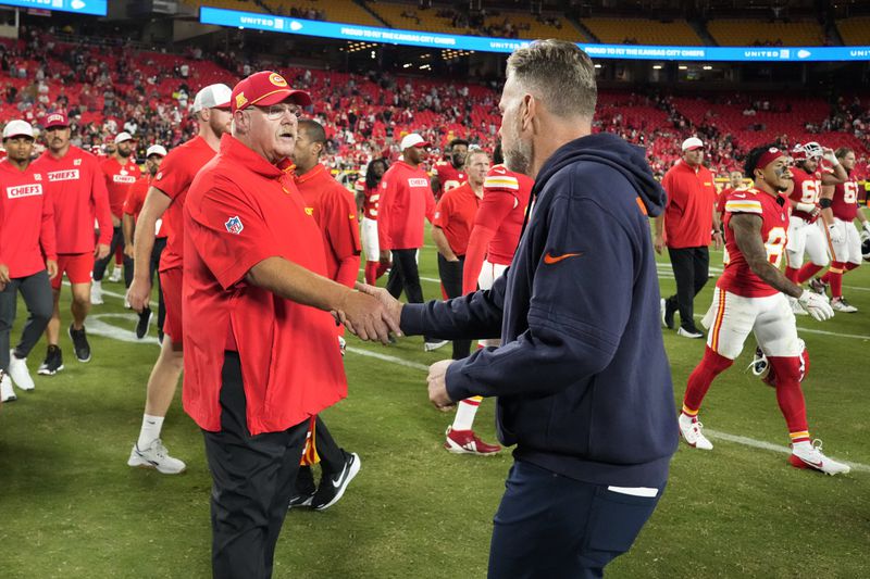 Kansas City Chiefs head coach Andy Reid, left, and Chicago Bears head coach Matt Eberflus shake hands following an NFL preseason football game Thursday, Aug. 22, 2024, in Kansas City, Mo. The Bears won 34-21. (AP Photo/Charlie Riedel)