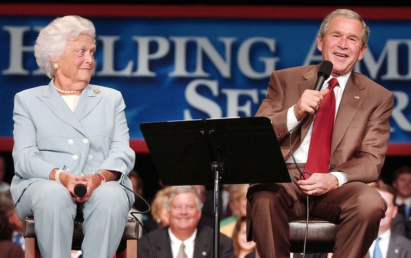 In this 2005 file photo, former first lady Barbara Bush keeps a mother’s watchful eye on President George W. Bush at the Boisfeuillet Jones Atlanta Civic Center..  (RICH ADDICKS/AJC staff)