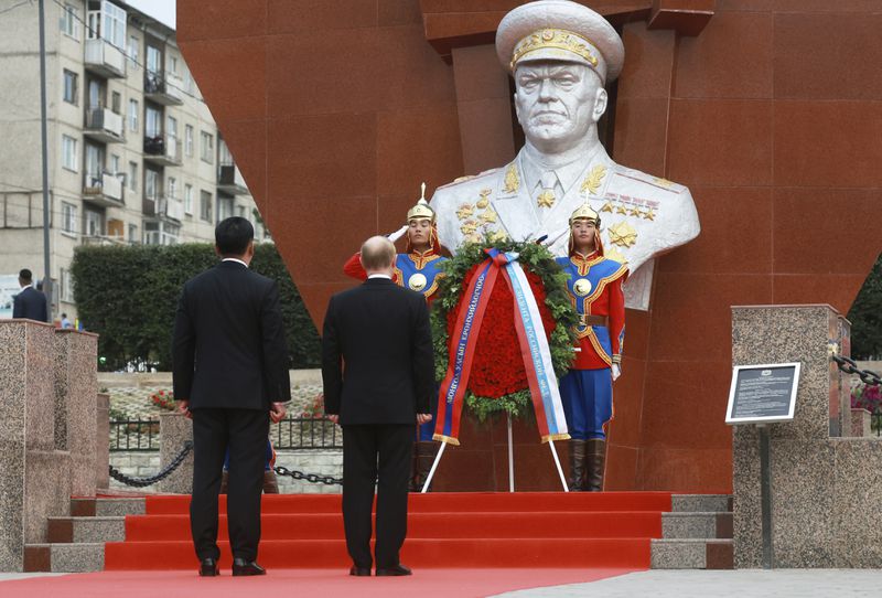 Russian President Vladimir Putin, on carpet front right, and Mongolian President Ukhnaagiin Khurelsukh, on carpet front left, attend a wreath-laying ceremony at the monument to Soviet Marshal Zhukov in Ulaanbaatar, Mongolia, Tuesday, Sept. 3, 2024. (Vyacheslav Prokofyev, Sputnik, Kremlin Pool Photo via AP)