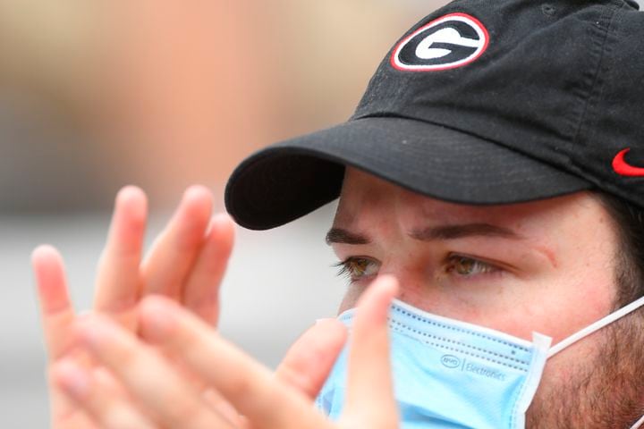 A Georgia fan cheers as warm ups are undertaken before a football game against Tennessee, Saturday, Oct. 10, 2020, at Sanford Stadium in Athens. JOHN AMIS FOR THE ATLANTA JOURNAL- CONSTITUTION