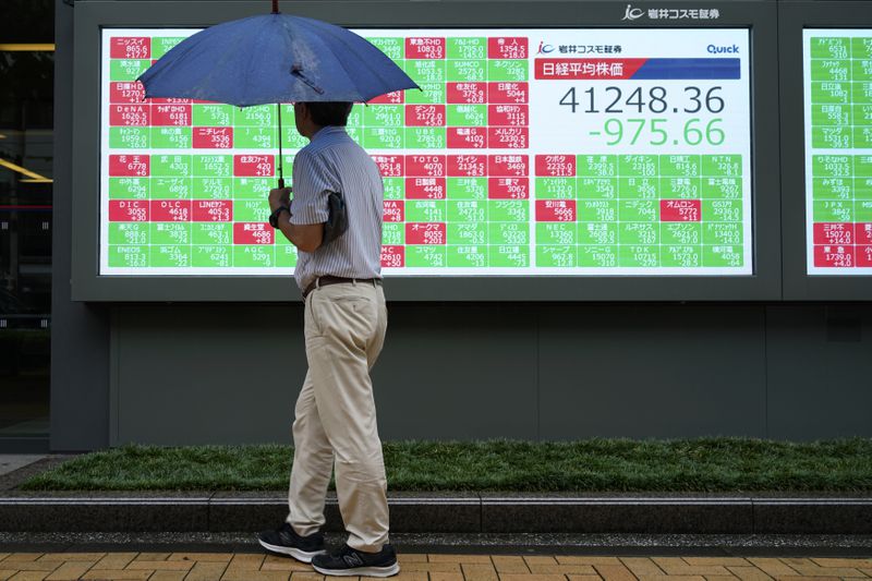 A person looks at an electronic stock board showing Japan's Nikkei index at a securities firm Friday, July 12, 2024, in Tokyo. (AP Photo/Eugene Hoshiko)
