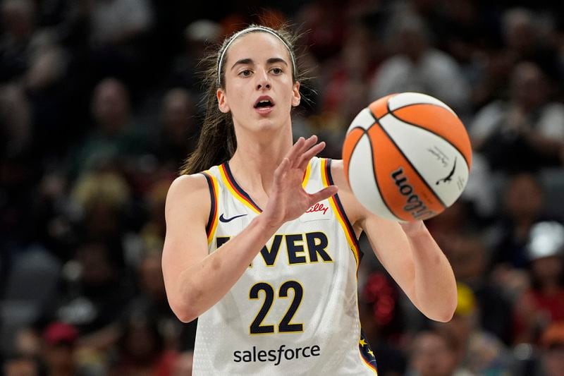 Indiana Fever guard Caitlin Clark (22) grabs a pass against the Las Vegas Aces during the first half of a WNBA basketball game Saturday, May 25, 2024, in Las Vegas. (AP Photo/John Locher)