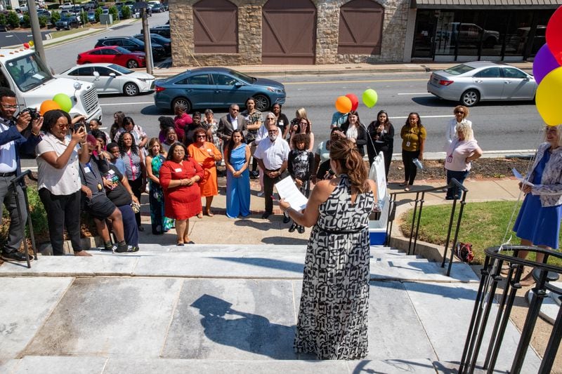 CHRIS 180’s Clinical Director Luz Soto Garcia, address the crowd along West Crogan Street in Lawrenceville to celebrate the therapy services expansion with a ribbon cutting and tours of the facility on Thursday, June 13, 2024.  The counseling services and trauma-informed care for children and families in Gwinnett County is now available in a new larger location allowing the office to grow from 5 to 15 therapists.  (Jenni Girtman for The Atlanta Journal-Constitution)  