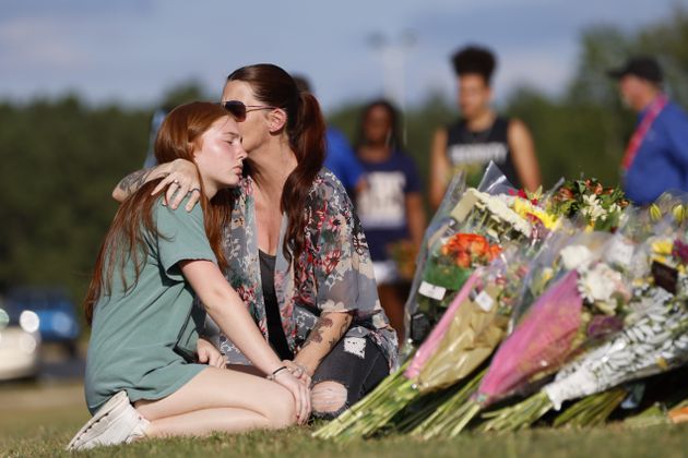 Stacey Andrews kisses her daughter, Payton Owen, 15, an Apalachee High School sophomore, as they pay their respect by the memorial outside the school on Thursday, Sept. 5, 2024. A 14-year-old is accused of shooting and killing two fellow students and two teachers and injuring nine others at Apalachee High School on Wednesday.
(Miguel Martinez / AJC)
