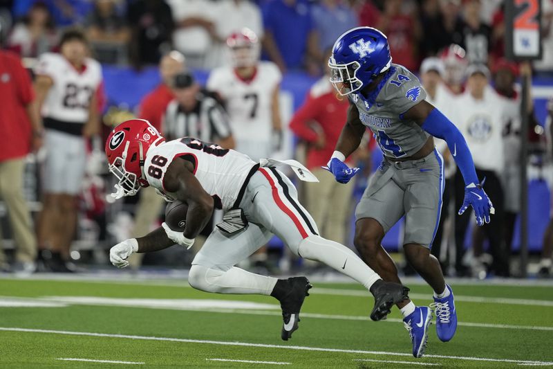 Georgia wide receiver Dillon Bell (86) makes a catch against Kentucky defensive back Ty Bryant (14) during the second half of an NCAA college football game, Saturday, Sept. 14, 2024, in Lexington, Ky. (AP Photo/Darron Cummings)