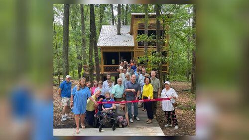 Members of Friends of Newton Parks, the Newtown County Chamber of Commerce and supporters of Chimney Park prepare to cut the ribbon on the park's new universally accessible treehouse. (Photo provided by Alice Queen)