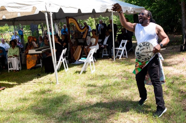 Dr. O’dyke Nzewi performs a West African ceremony during a Juneteenth celebration at the Pierce Chapel African Cemetery in Midland, outside of Columbus, on Monday, June 20, 2022. The cemetery was rediscovered in 2019 and work has since been done to clean, document and preserve it. Ben Gray for the Atlanta Journal-Constitution