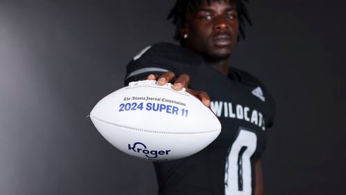 2024 AJC Super 11 Schley County linebacker Zayden Walker poses with an Atlanta Journal-Constitution Super 11 football at Schley County high school, Tuesday, July 30, 2024, in Ellaville Ga. (Jason Getz / AJC)
