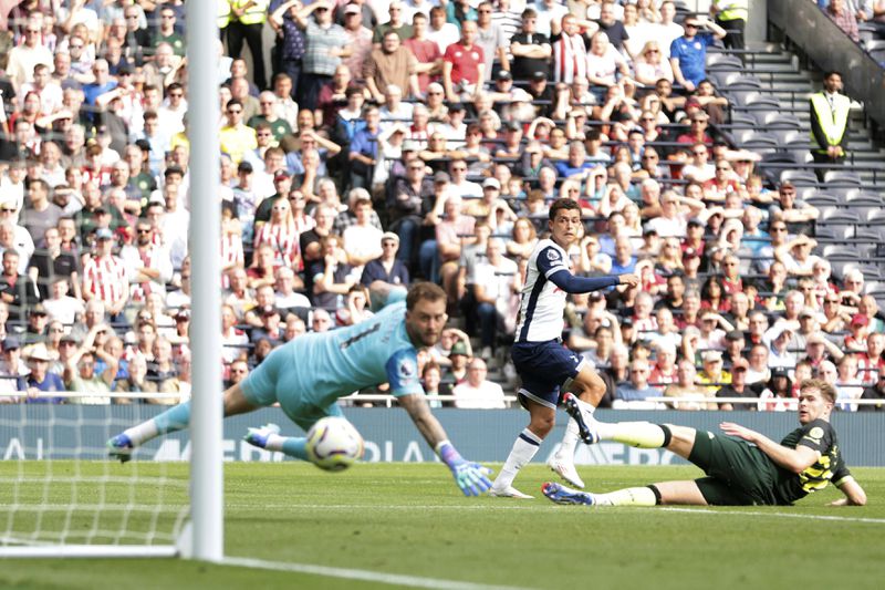 Tottenham Hotspur's Brennan Johnson, center scores his side's second goal of the game, during the English Premier League soccer match between Tottenham Hotspur and Brentford, at the Tottenham Hotspur Stadium, in London, Saturday, Sept. 21, 2024. (Steven Paston/PA via AP)