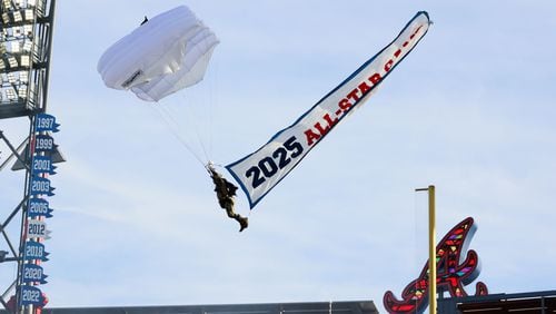 A parachute enters Truist Park Monday during the ceremonies for the unveiling of the 2025 All-Star Game logo.
(Miguel Martinez/ AJC)