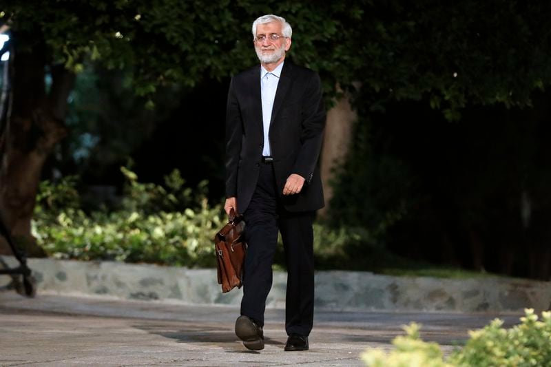 In this picture made available by Iranian state-run TV, IRIB, candidate for the presidential election Saeed Jalili, a hard-line former Iranian top nuclear negotiator, arrives for his debate with the reformist candidate Masoud Pezeshkian at the TV studio in Tehran, Iran, Monday, June 1, 2024. (Morteza Fakhri Nezhad/IRIB via AP)