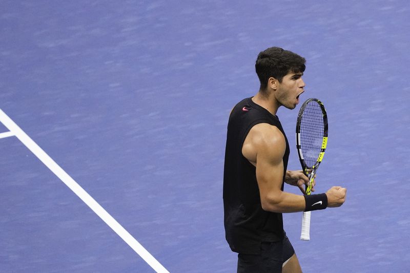 Carlos Alcaraz, of Spain, reacts after scoring a point against Botic van De Zandschulp, of the Netherlands, during the second round of the U.S. Open tennis championships, Thursday, Aug. 29, 2024, in New York. (AP Photo/Matt Rourke)