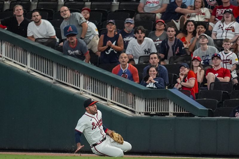 Atlanta Braves outfielder Ramón Laureano (18) makes the catch against Philadelphia Phillies' Nick Castellanos (8) during the eighth inning of a baseball game, Tuesday, Aug. 20, 2024, in Atlanta. (AP Photo/Mike Stewart)