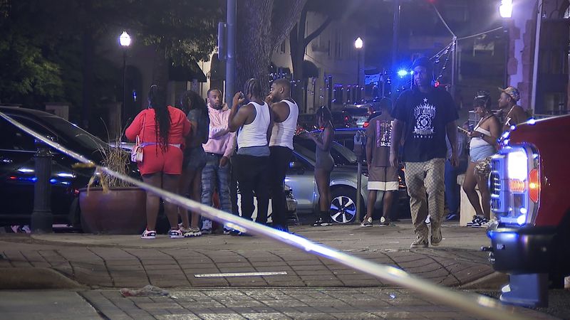 This image provided by WBMA shows bystanders near the scene of a shooting in Birmingham, Ala., Sunday, Sept. 22, 2024. (Bill Castle/WBMA via AP)