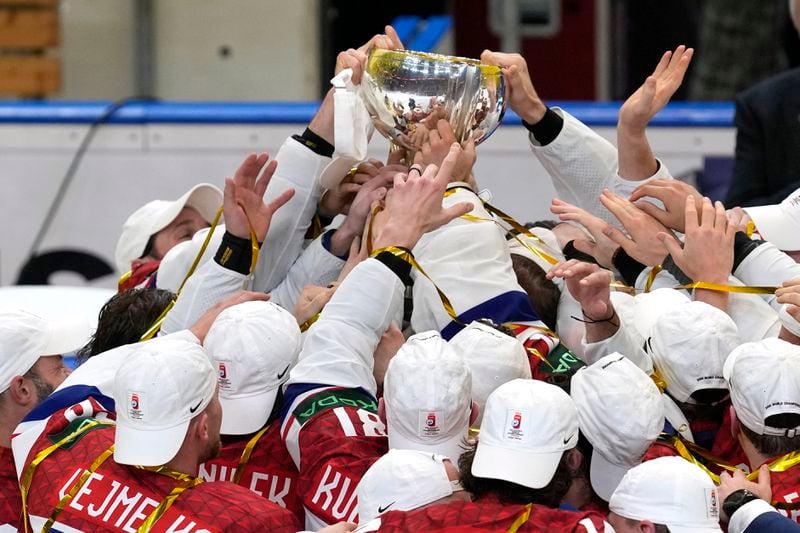 Members of the Czech Republic team celebrate with their trophy after they defeated Switzerland 2-0 in a gold medal match at the Ice Hockey World Championships in Prague, Czech Republic, Sunday, May 26, 2024. (AP Photo/Darko Vojinovic)