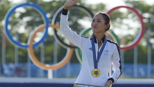 Lydia Ko, of New Zealand, waves to the crowd wearing her gold medal during the medal ceremony following the final round of the women's golf event at the 2024 Summer Olympics, Saturday, Aug. 10, 2024, at Le Golf National, in Saint-Quentin-en-Yvelines, France. (AP Photo/Matt York)