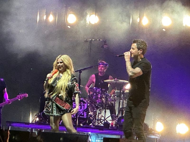 Avril Lavigne brought Simple Plan singer Pierre Bouvier and his band on stage to perform Simple Plan "Addicted" during their sold-out concert at the Ameris Bank Amphitheatre in Alpharetta on September 3, 2024. RODNEY HO/rho@ajc.com