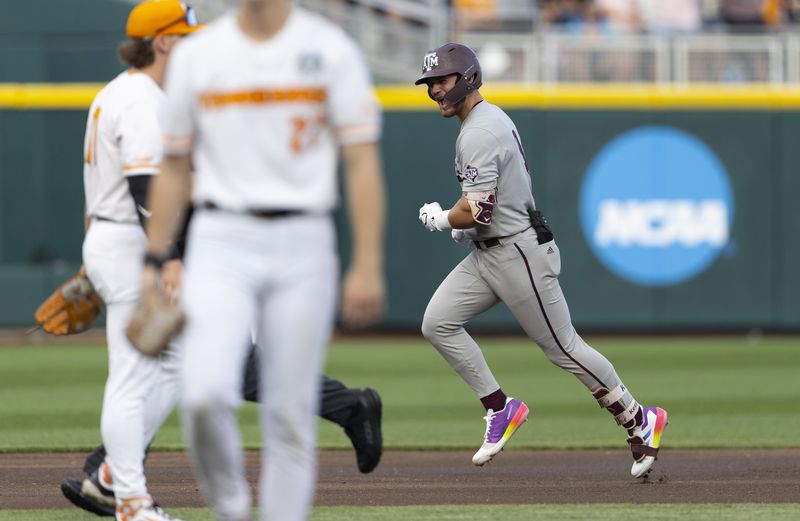 Texas A&M's Gavin Grahovac, right, runs the bases on a home run against Tennessee during the first inning of Game 1 of the NCAA College World Series baseball finals in Omaha, Neb., Saturday, June 22, 2024. (AP Photo/Rebecca S. Gratz)