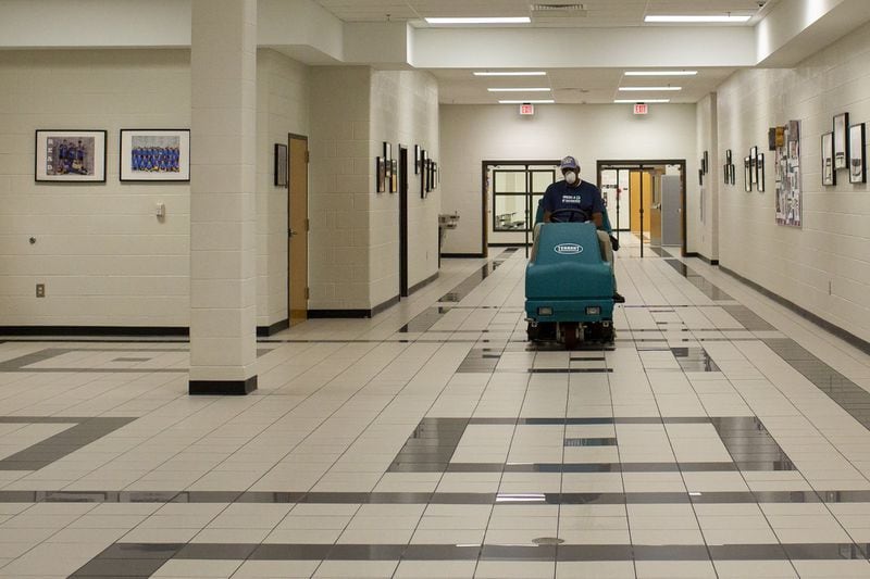 Jerry Greer, a custodian at Northbrook Middle School in Suwanee, Georgia, cleans the hallways on Wednesday, July 8, 2020. Northbrook Middle School is amping up their cleaning and disinfecting practices, creating social distancing protocols and posting signage to help reduce the risk of students spreading COVID-19 when schools reopen Aug. 12. 