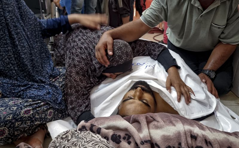 Palestinians mourn a relative killed in the Israeli bombardment of the Gaza Strip, at a hospital in Khan Younis, Saturday, Aug. 24, 2024. (AP Photo/ Mohammad Jahjouh)