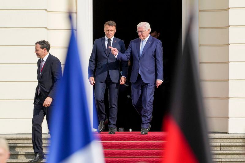 German President Frank-Walter Steinmeier, right, and French President Emmanuel Macron walk to a press conference at Bellevue Place in Berlin, Germany, Sunday, May 26, 2024. (AP Photo/Markus Schreiber)