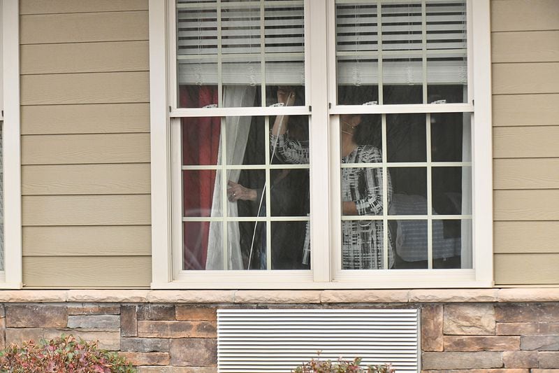 Senior living facility staff close a window at The Retreat at Canton, where confirmed that three residents and an employee have tested “presumptively positive” for COVID-19, on Tuesday, March 17, 2020. A second senior care facility, PruittHealth — Grandview, on Tuesday reported a positive test for the virus.(Hyosub Shin / Hyosub.Shin@ajc.com)