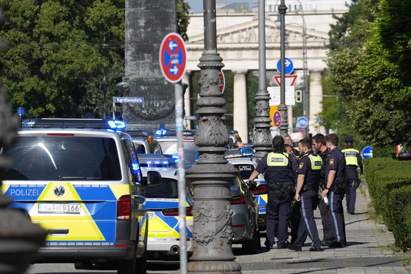 Police officers stand at a street after police fired shots at a suspicious person near the Israeli Consulate and a museum on the city's Nazi-era history in Munich, Germany, Thursday, Sept. 5, 2024. (AP Photo/Matthias Schrader)