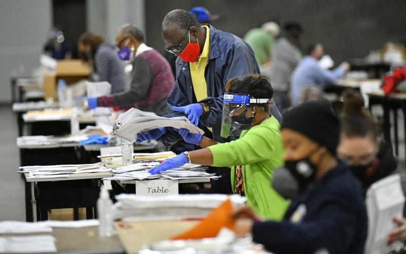 Fulton County's members of a recount team work on hand recount and audit of ballots in the presidential race at the Georgia World Congress Center on Saturday, November 14, 2020. (Photo: Hyosub Shin / Hyosub.Shin@ajc.com)