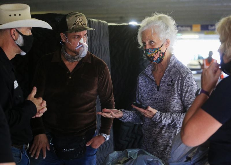 Jeff Carson from Midwest Food Bank (from left); Daniel de los Reyes, percussionist for the Zac Brown Band; Maria Brunner, head of Musically Fed; and Gail Frantz, from Midwest Food Bank have a discussion during the Musically Fed food drive Oct. 29 at the Infinite Energy Center in Duluth. CHRISTINA MATACOTTA FOR THE AJC