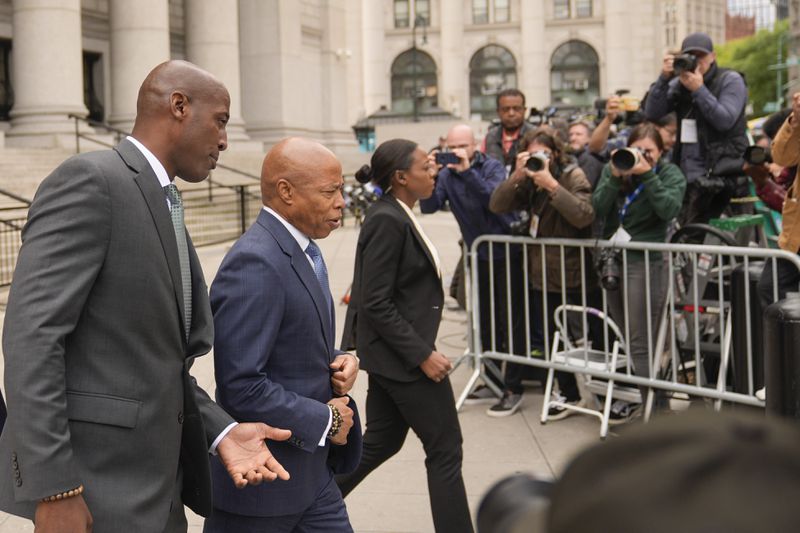 New York City Mayor Eric Adams, second from left, leaves the courthouse in New York, Wednesday, Oct. 2, 2024. (AP Photo/Seth Wenig)