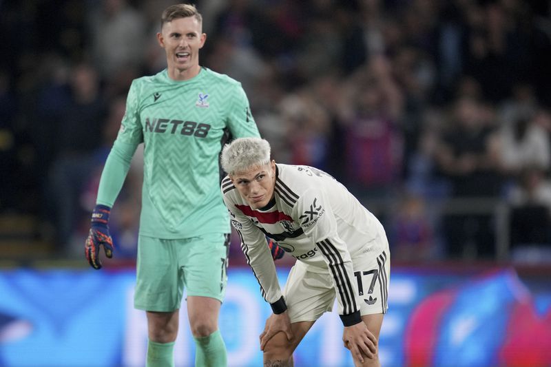 Manchester United's Alejandro Garnacho and Crystal Palace's goalkeeper Dean Henderson, left, react at the end of the English Premier League soccer match between Crystal Palace and Manchester United at Selhurst Park in London, Saturday, Sept. 21, 2023. (AP Photo/Kin Cheung)