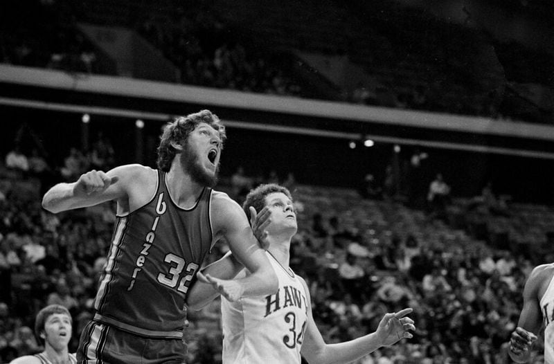 Portland Trail Blazers center Bill Walton (32) gapes as he grapples with Atlanta Hawks center Randy Denton in first period action at Atlanta Omni, Jan. 16, 1977, jockeying for position on a rebound. Walton won the arm wrestling action and got the rebound in their NBA game. (AP Photo/OBJ)