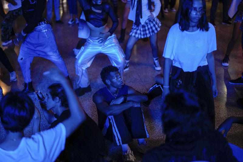 Teenagers dance to K-pop, popular Korean music, at a cultural house in Havana, Cuba, Saturday, Sept. 7, 2024. (AP Photo/Ramon Espinosa)