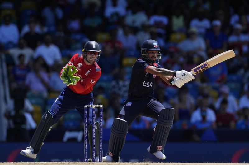 United States' Nitish Kumar, right, plays a shot during the ICC Men's T20 World Cup cricket match between the United States and England at Kensington Oval in Bridgetown, Barbados, Sunday, June 23, 2024. (AP Photo/Ricardo Mazalan)
