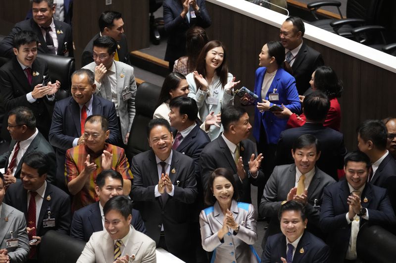 Pheu Thai party lawmakers celebrate after Thailand’s Parliament elected the party's leader Paetongtarn Shinawatra as the country’s new prime minister at Parliament in Bangkok, Thailand, Friday, Aug. 16, 2024. (AP Photo/Sakchai Lalit)