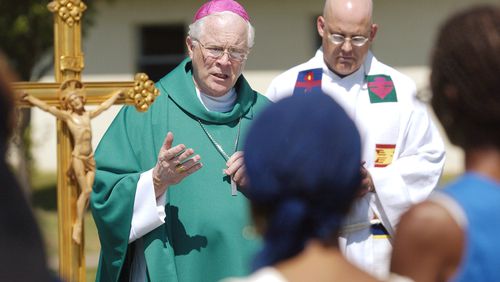 FILE - Edward Slattery, bishop of the Diocese of Tulsa, celebrates Mass in a courtyard for about 30 people Monday, Sept. 5, 2005, at Camp Gruber, in Braggs, Okla. (Jim Beckel/The Oklahoman via AP)