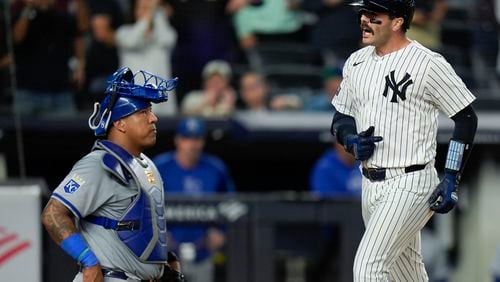 Kansas City Royals catcher Salvador Perez, left, looks on as New York Yankees' Austin Wells, right, crosses home plate after hitting a three-run home run during the seventh inning of a baseball game at Yankee Stadium, Monday, Sept. 9, 2024, in New York. (AP Photo/Seth Wenig)