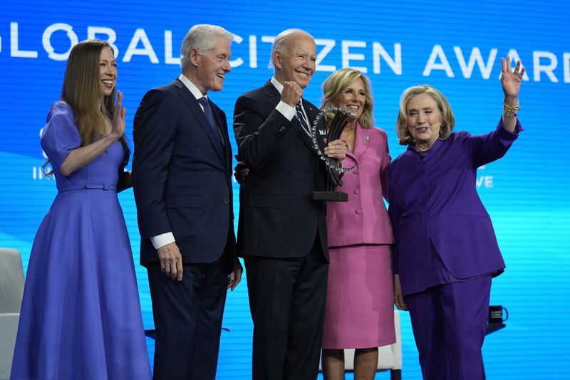 President Joe Biden is presented with the Global Citizen Award by Chelsea Clinton, former President Bill Clinton, first lady Jill Biden and former Secretary of State Hillary Clinton at the Clinton Global Initiative Monday, Sept. 23, 2024, in New York. (AP Photo/Manuel Balce Ceneta)