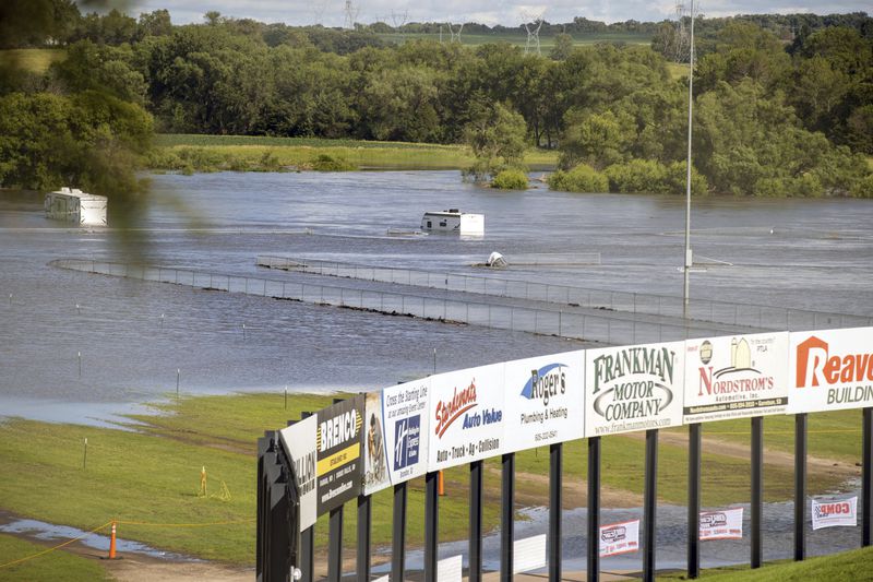 Campers and RVs at Husets Speedway are submerged in floodwaters after days of heavy rain led to flooding in the area south of Brandon, S.D., Saturday, June 22, 2024. (AP Photo/Josh Jurgens)