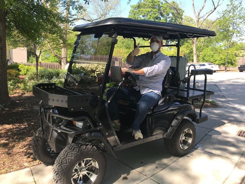 Ryan Pernice of RO Hospitality sits in a golf cart that was donated to his restaurant group that serves the communities of Roswell and Alpharetta. The golf card is used to transport fried chicken prepared at Table and Main to sister restaurant Osteria Mattone. Pernice called the fried chicken the saving grace of this company as it struggles to stay afloat right now, with revenue down 70% company-wide and the staff pared down from 120 to 30. LIGAYA FIGUERAS/LIGAYA.FIGUERAS@AJC.COM