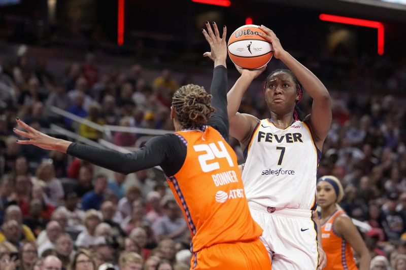 Indiana Fever forward Aliyah Boston (7) shoots over Connecticut Sun forward DeWanna Bonner (24) in the second half of a WNBA basketball game in Indianapolis, Wednesday, Aug. 28, 2024. (AP Photo/Michael Conroy)