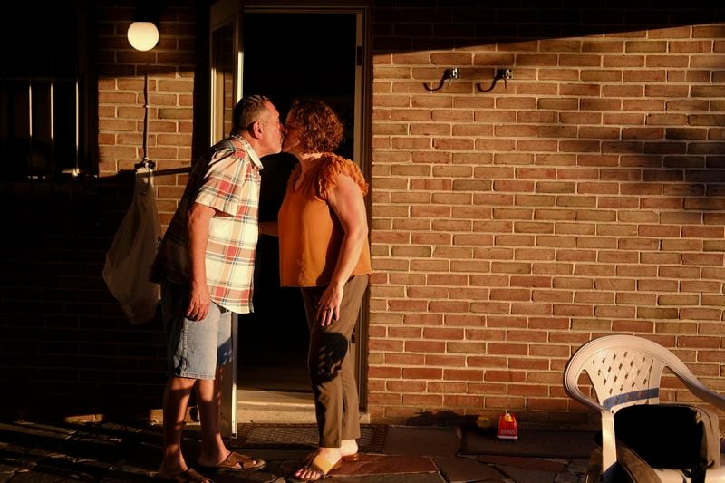 Mayor Eddie Moran kisses his wife, Ruth Moran, during a family BBQ held at his sister's home in Reading, Pa., on Sunday, June 16, 2024. “Right now, with the growing Latino population and the influx of Latinos moving into cities such as Reading, it’s definitely an opportunity for the Latino vote to change the outcome of an election," the mayor says. “It's not a secret anymore.” (AP Photo/Luis Andres Henao)