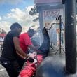 Employees at Lanier's Fresh Meat Market grilled hotdogs for local residents on Monday, September 30, 2024. (Photo Courtesy of Charmain Z. Brackett/Augusta Good News)