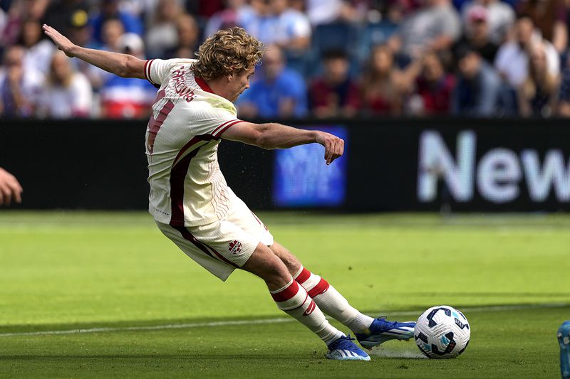 Canada forward Jacob Shaffelburg scores a goal during the first half of an international friendly soccer game against Canada, Saturday, Sept. 7, 2024, in Kansas City, Mo. (AP Photo/Charlie Riedel)