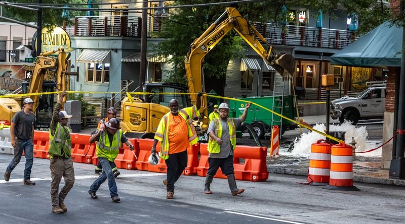 Crews work Monday on a broken main on West Peachtree Street at 11th Street in Midtown.