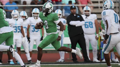 Roswell quarterback Trey Smith (8) runs for a 55-yard touchdown run during the first half against Seckinger at Roswell High School, Friday, Sept. 20, 2024, in Roswell, Ga. (Jason Getz / AJC)

