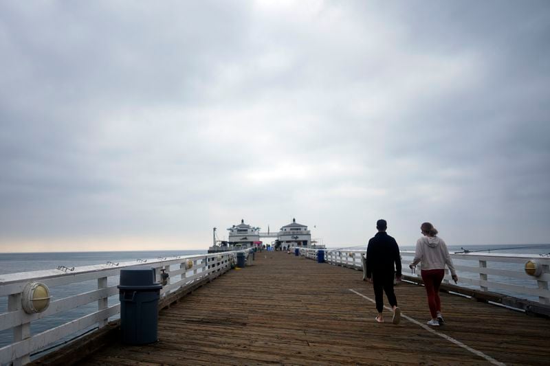 Visitors walk on the pier Thursday, Sept. 12, 2024, in Malibu, Calif., following a 4.7 magnitude earthquake in the area. (AP Photo/Eric Thayer)